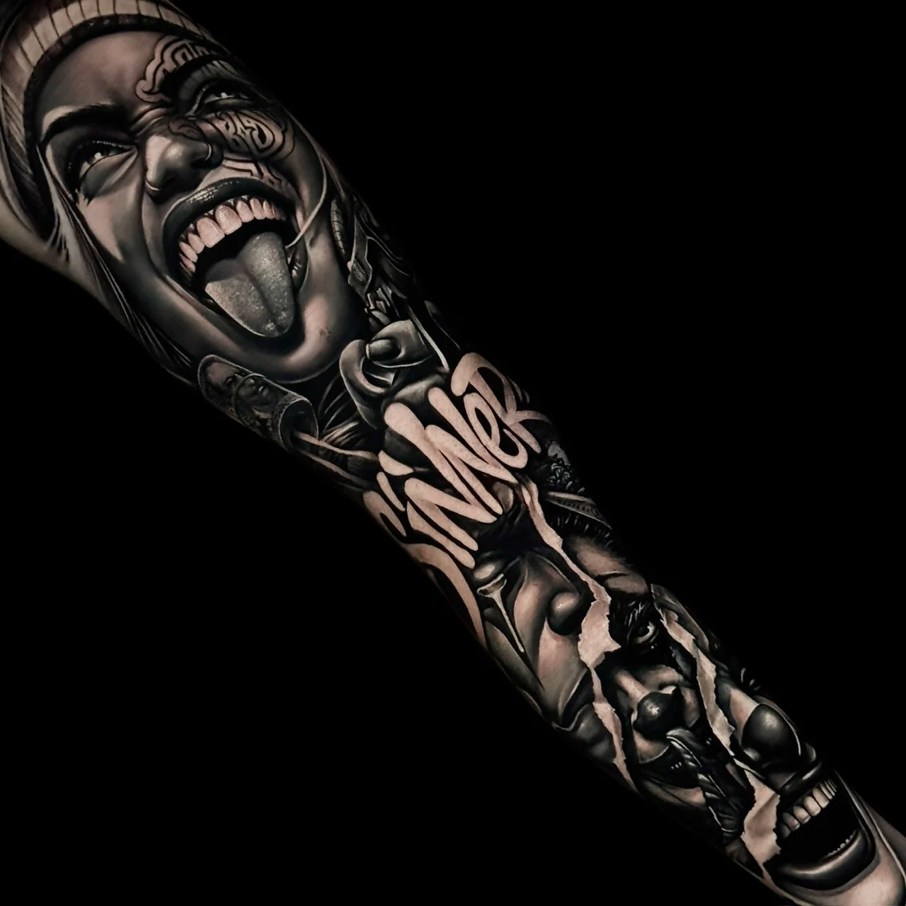 Black and grey Chicano arm sleeve tattoo featuring a defiant woman portrait, bold Sinner script, and a layered payasa clown girl at Bloodline Tattoo Bangkok.
