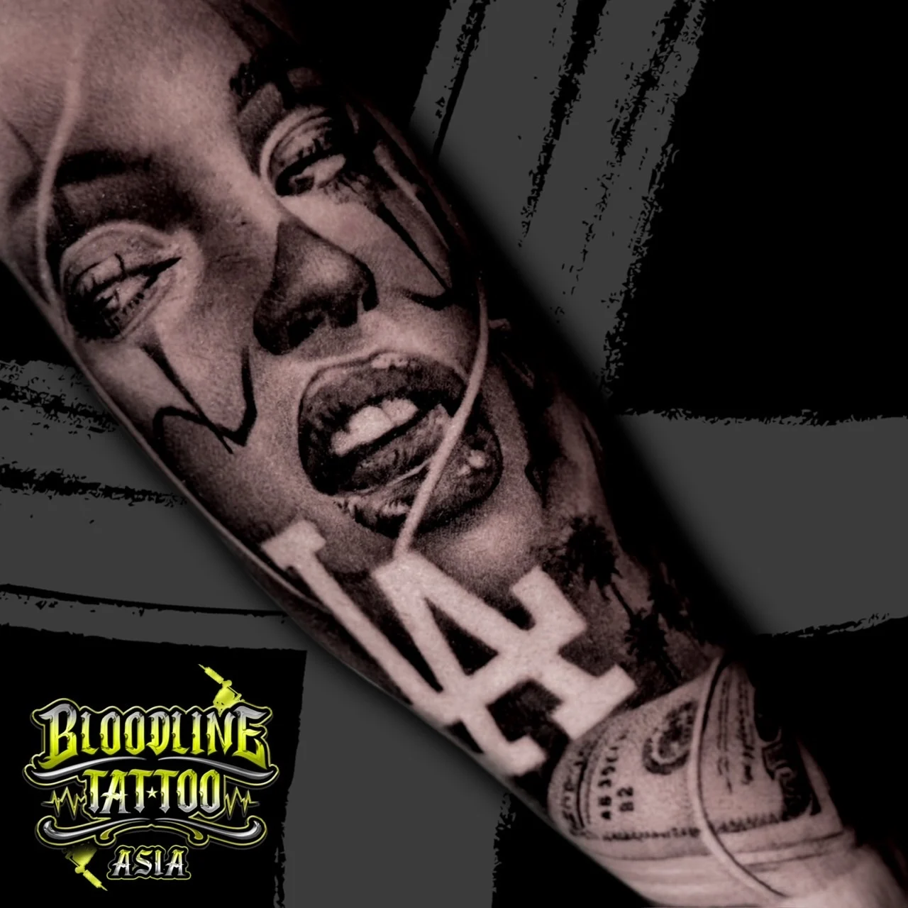 Detailed black and grey Chicano arm tattoo with a payasa portrait, bold LA lettering, palm trees, and a rolled hundred-dollar bill at Bloodline Tattoo Bangkok.
