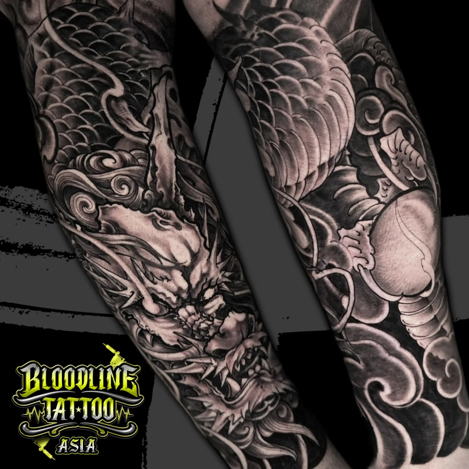 Black and grey Japanese Irezumi dragon wrap tattoo with detailed scales, whiskers, and traditional cloud background at Bloodline Tattoo Bangkok.