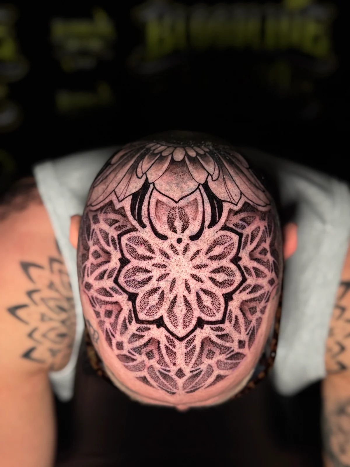 Crown scalp mandala with layered lotus petals and stippled dotwork shading across the shaved head, at Bloodline Tattoo Bangkok.