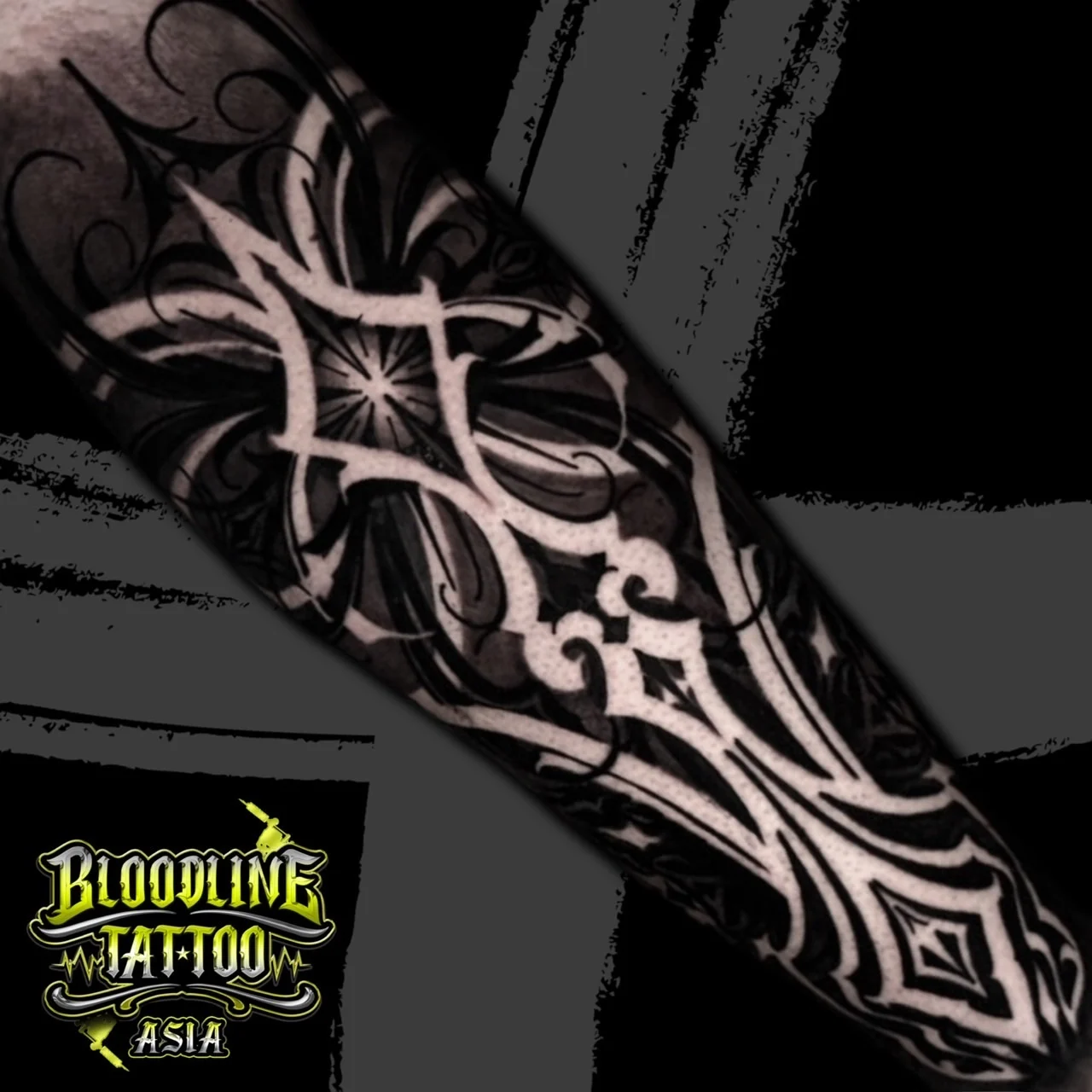 High-contrast ornamental blackwork sleeve using negative-space geometric lines, sunburst motifs, and filigree on saturated black fill, at Bloodline Tattoo Bangkok.