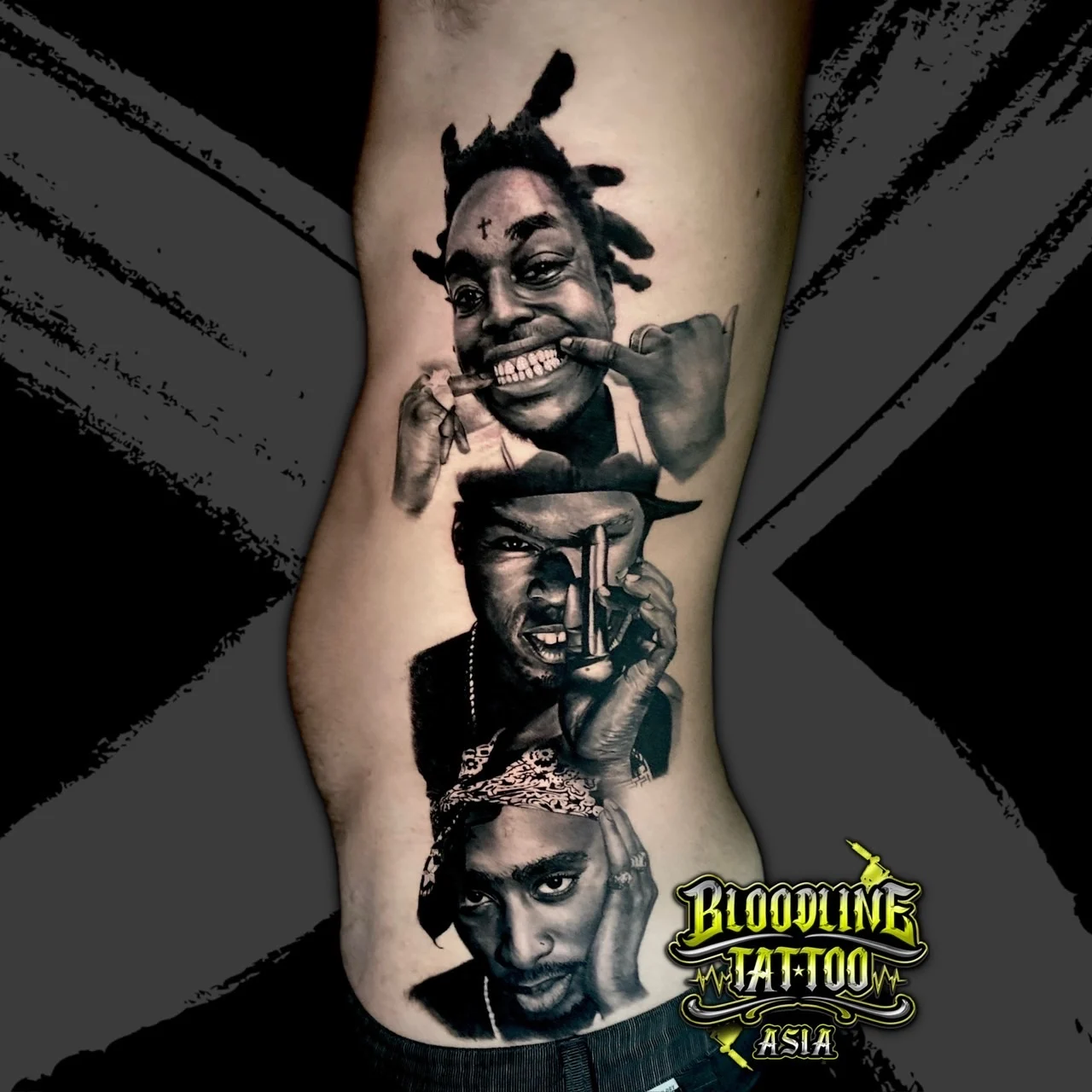 Black and grey portrait realism rib tattoo stack featuring Kodak Black, 50 Cent, and Tupac Shakur in bandana at Bloodline Tattoo Bangkok.